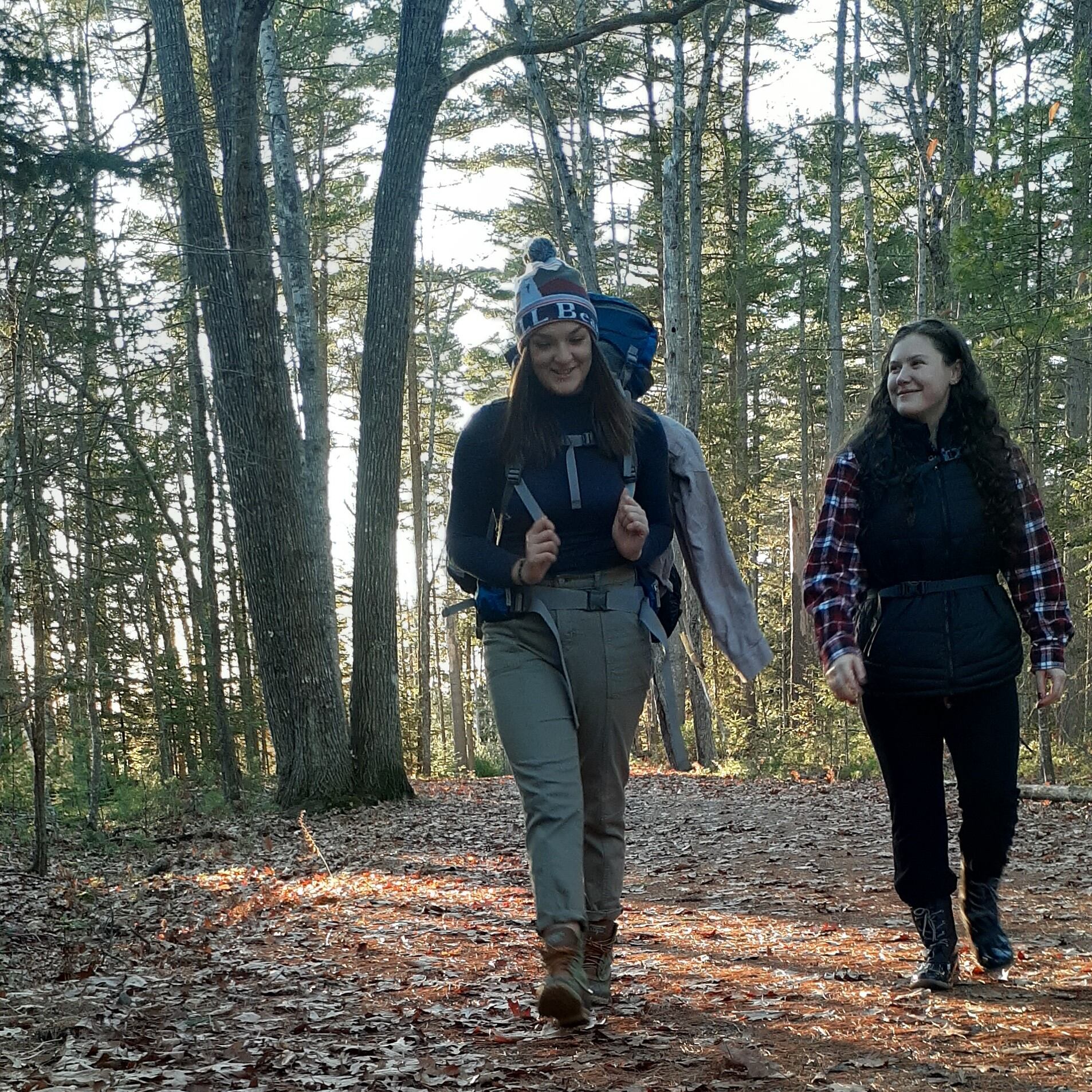Hikers along flat trail.