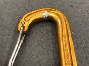 Inside of carabiner is grooved from contact with another metal edge.