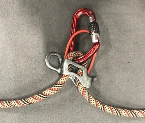 An ATC connected to the a rope with a carabiner