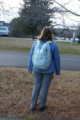 Student with a backpack on, used to protect against a bear attack.