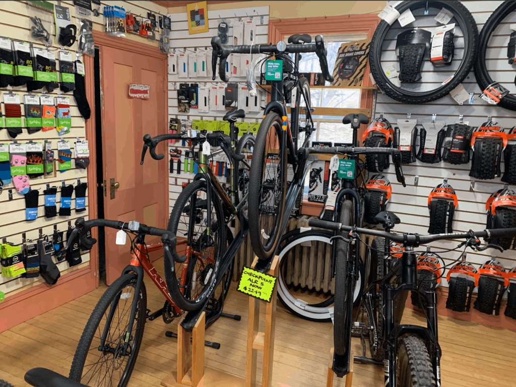 mountain bikes in a bike shop raised on pedestals, where the taller pedestals are on the inside and the shorter pedestals are on the outside