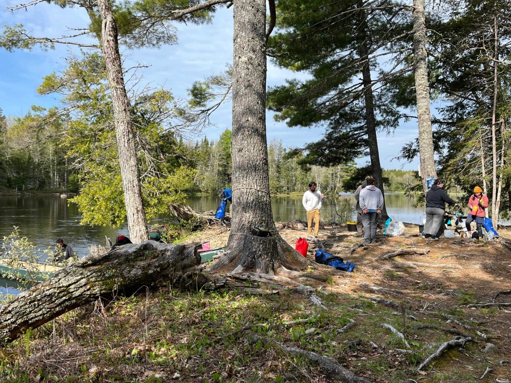 A canoeing campsite on a point of a river
