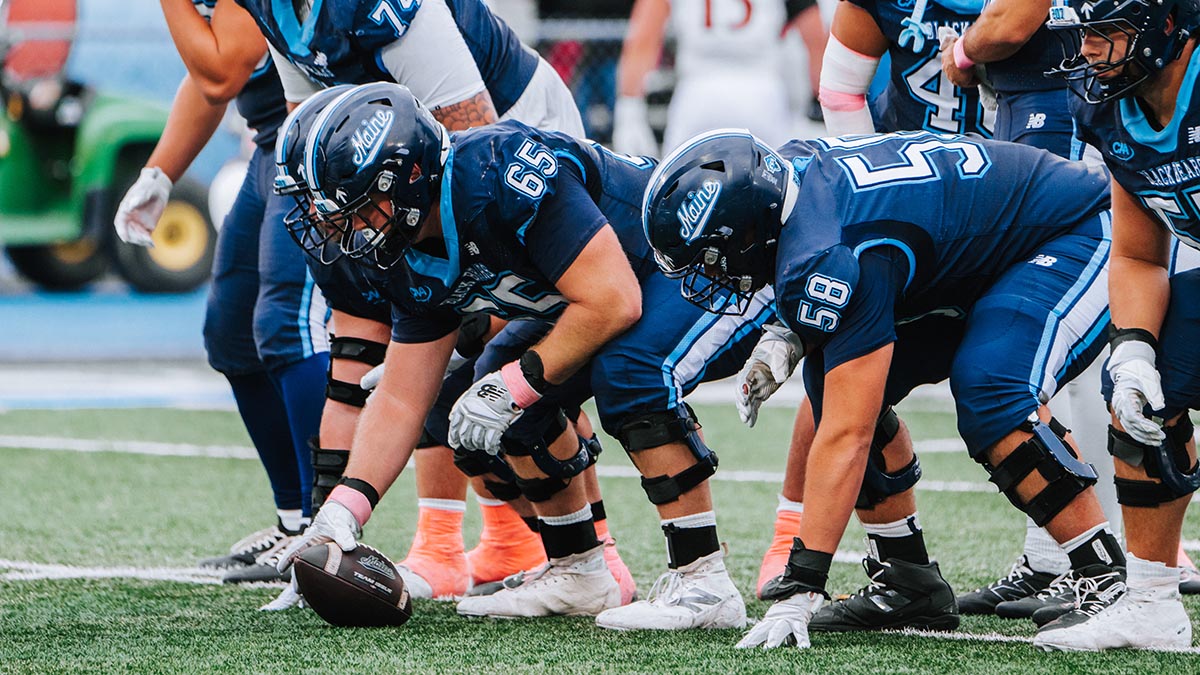 A photo of UMaine football players on the field