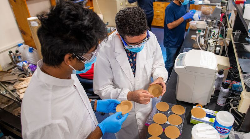 People in lab coats work with products made from nanocellulose.
