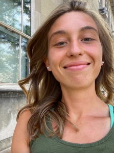 Portrait of Graduate Student Kathleen Duncan smiling into camera and wearing a green top