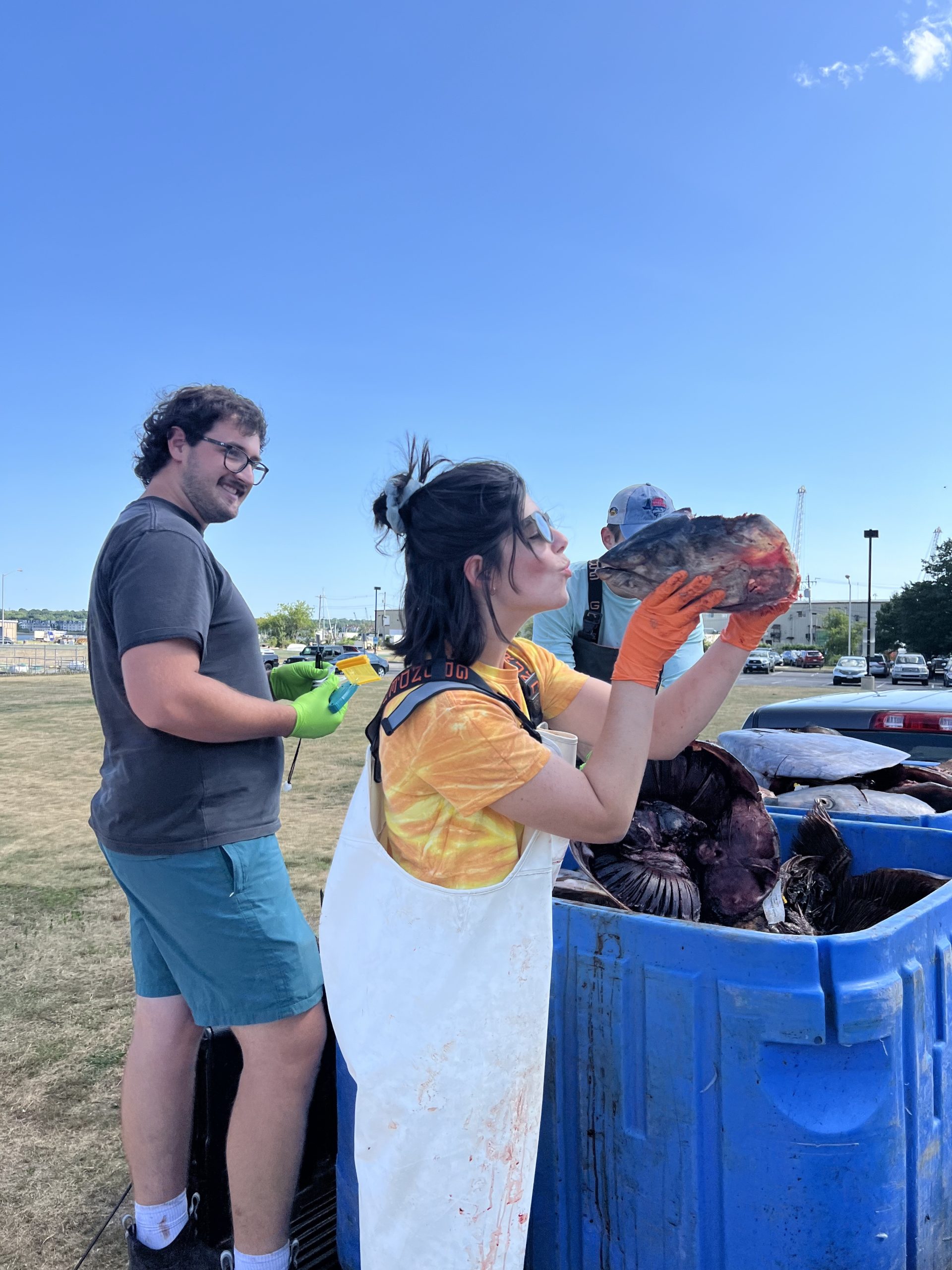 Our 2024 Technicians, Hayden & Amelia, dropping off some tuna heads they collected from Massachusetts. The smaller tuna head is a tropical tuna, not an Atlantic bluefin tuna. Amelia can be seen almost kissing a tropical tuna head, while Hayden is laughing with her.
