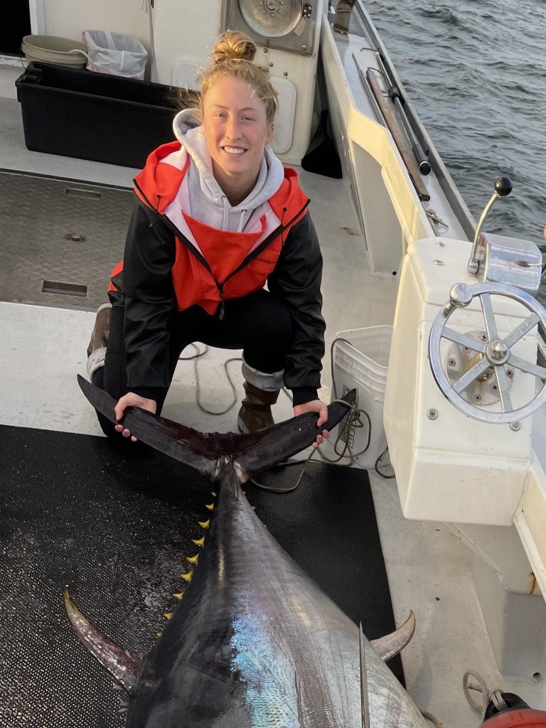 Sammi Nadeau, past Graduate student and now Lab Manager of the Pelagic fisheries lab, holding an Atlantic bluefin tuna that was caught in the Gulf of Maine.
