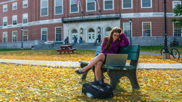 student sitting outside fogler library