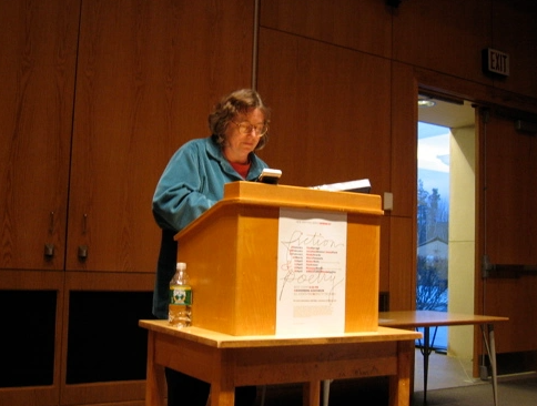 Tina Daragh reading behind a podium