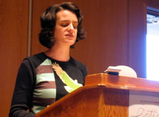 Allison Cobb reading behind a podium