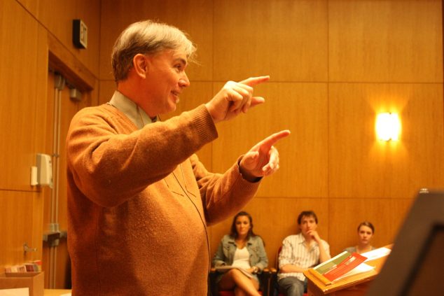 Photo of Donald Revell speaking to crowd in the Soderberg Auditorium