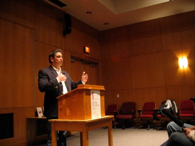 Richard Blanco speaking to audience behind a podium