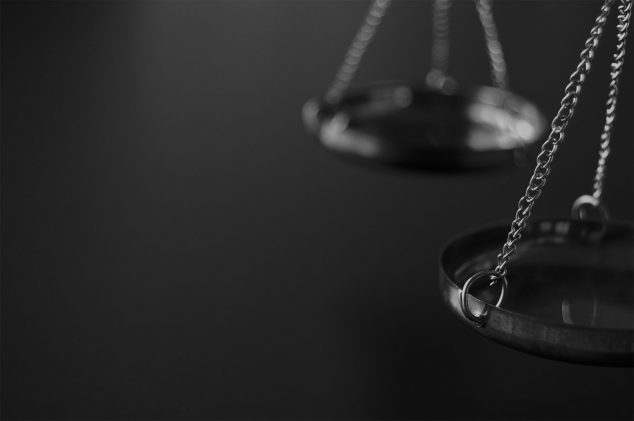 black and white image of the scales of justice