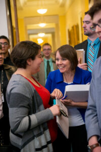 Student talking with legislator