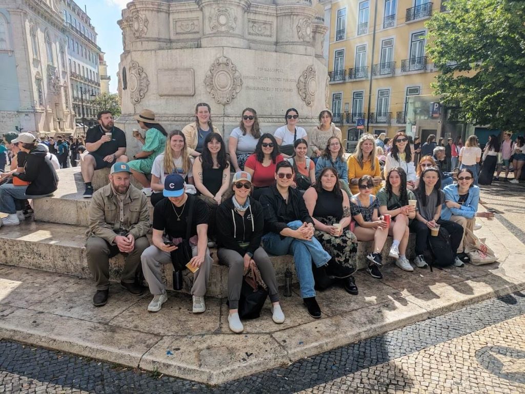 students sitting in a square in Lisbon, Portgal