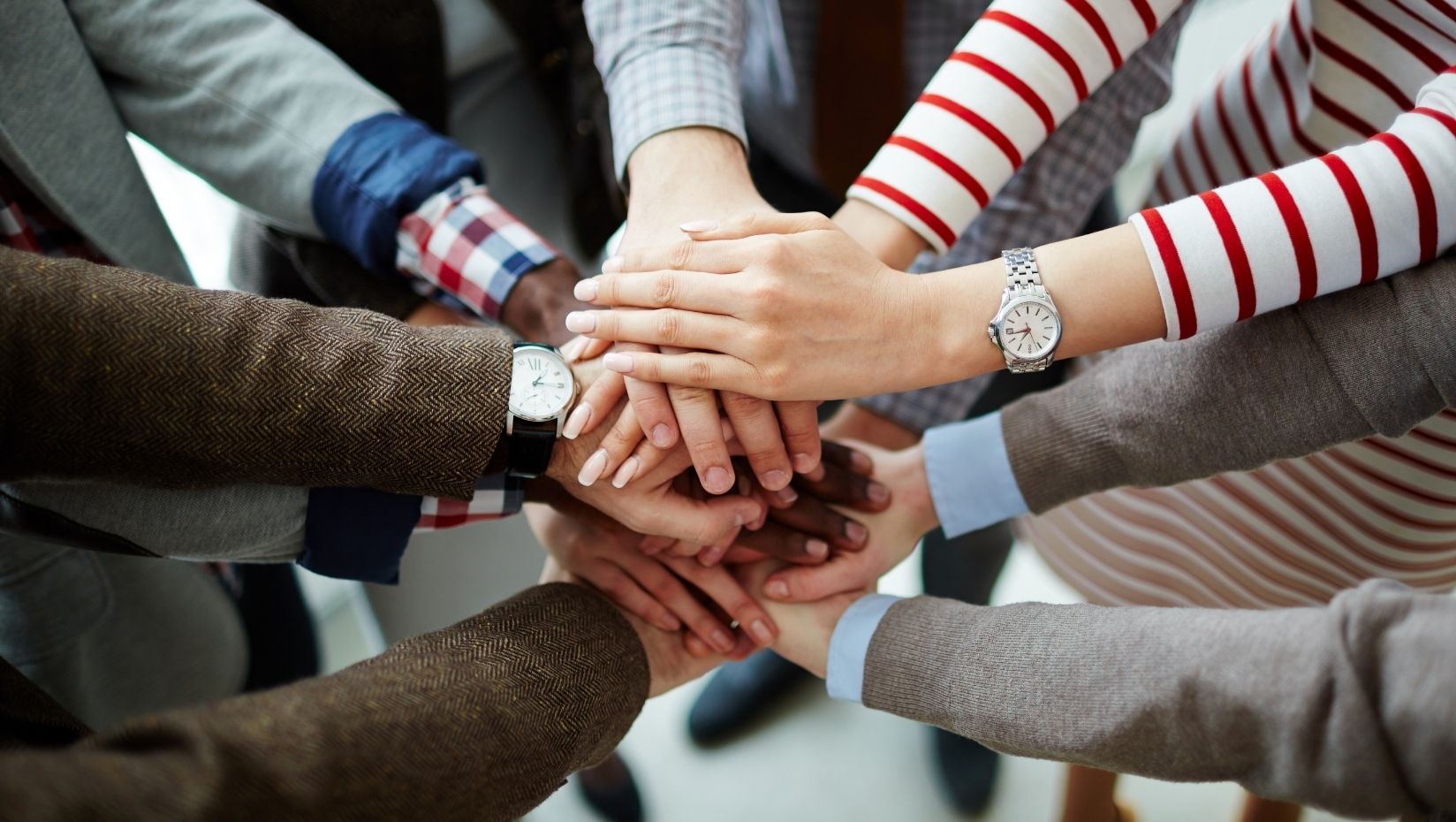 image of people's hands together