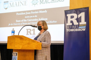 President Joan Ferrini-Mundy at the podium in Minsky Hall for the March 8 State of the University address