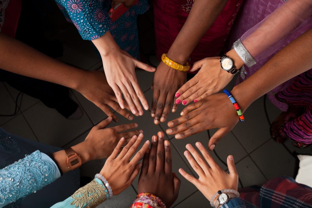 A stock image of hands put together in a circle