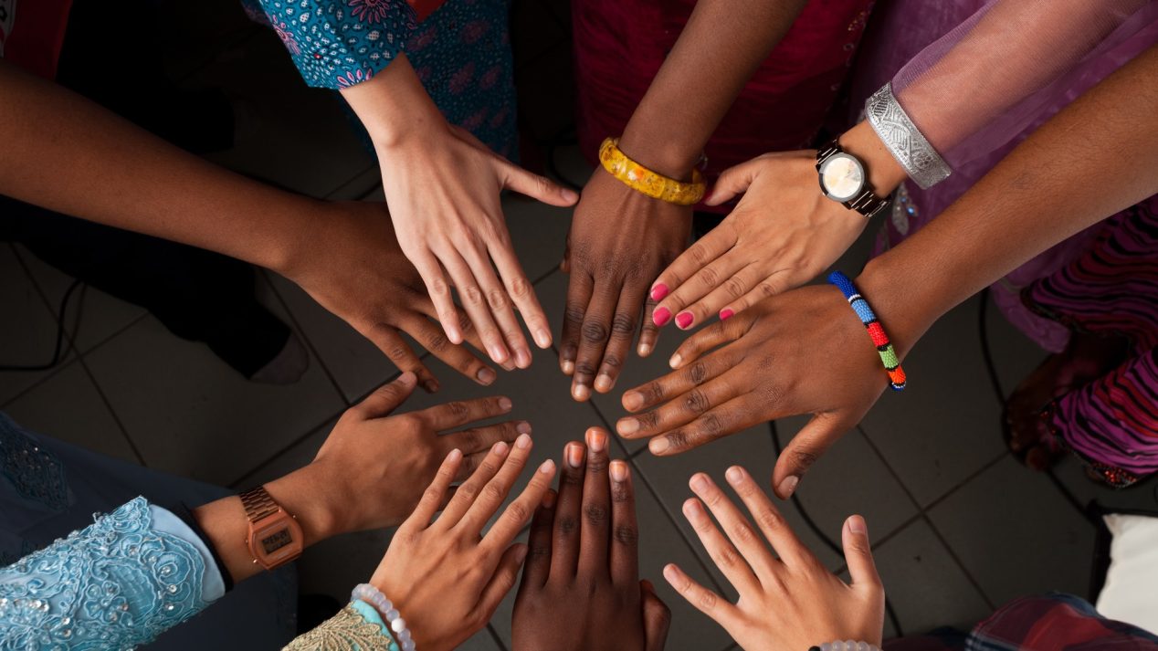 A stock image of hands put together in a circle