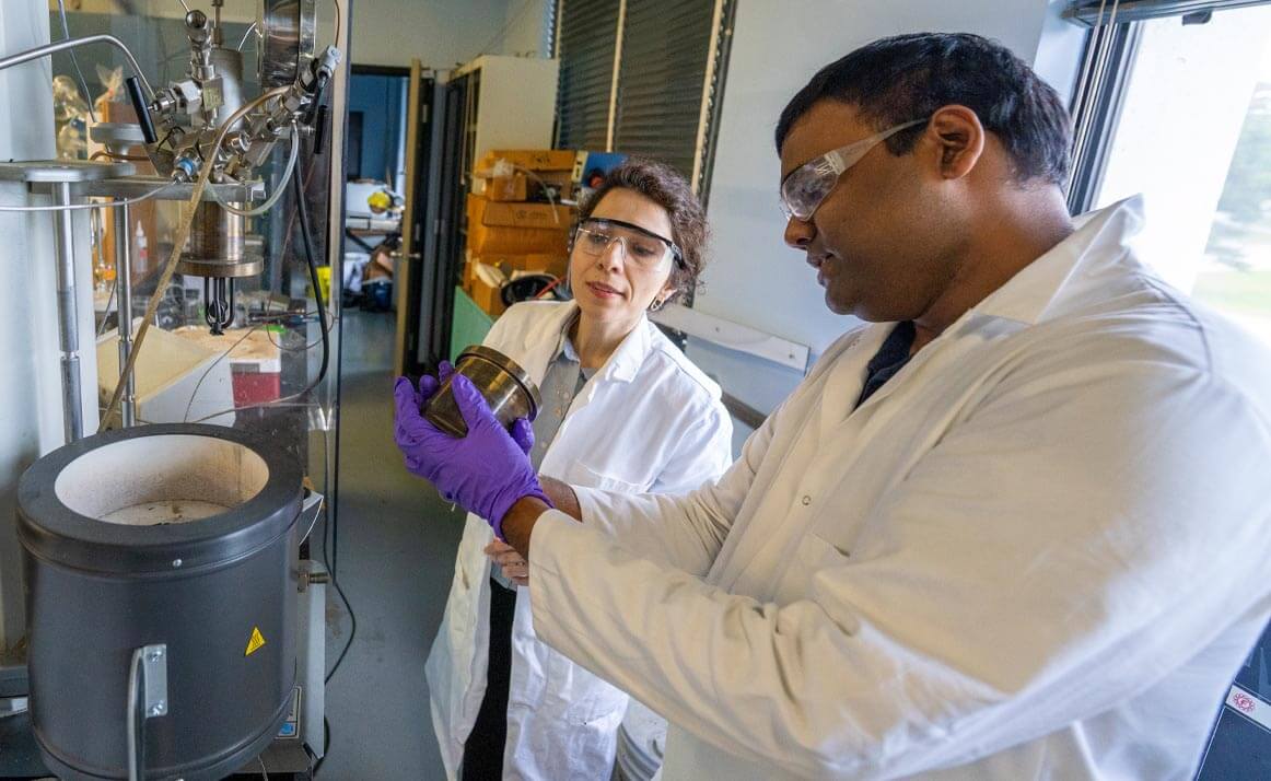 A photo of two people working in a lab