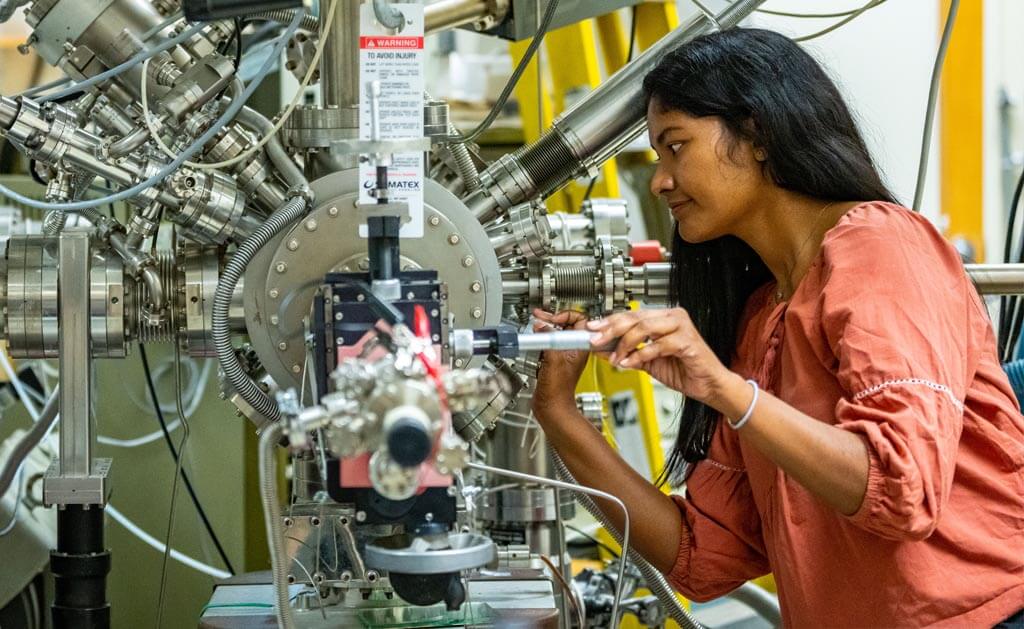 A photo of a woman working on a machine