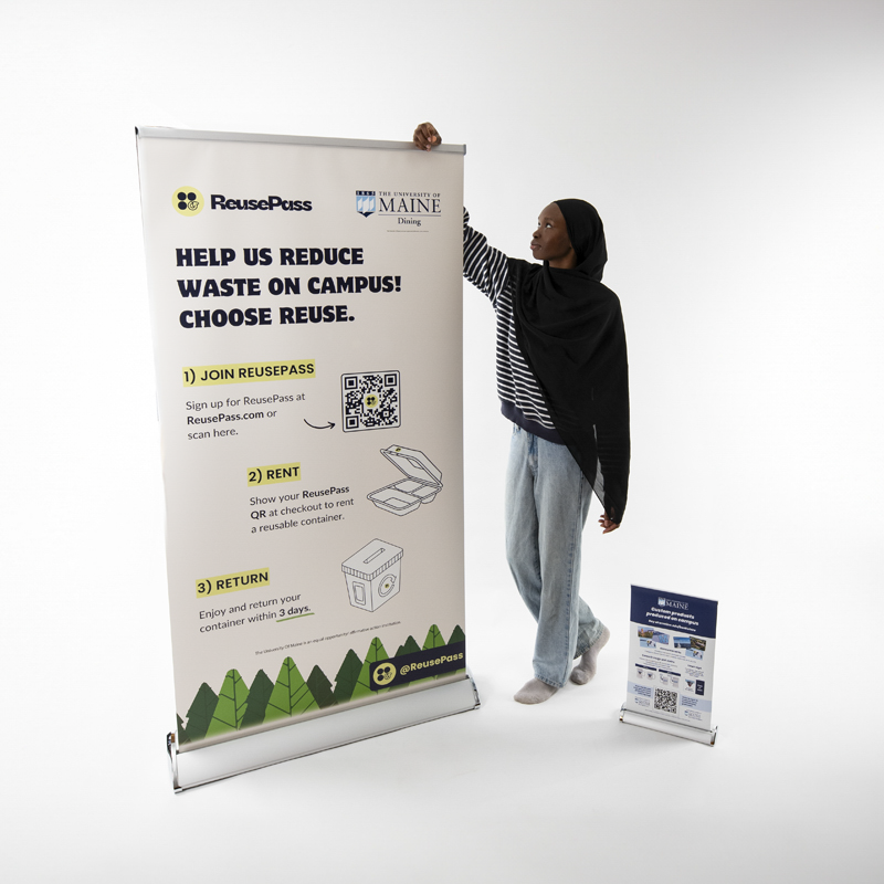 Woman standing next to retractable banner