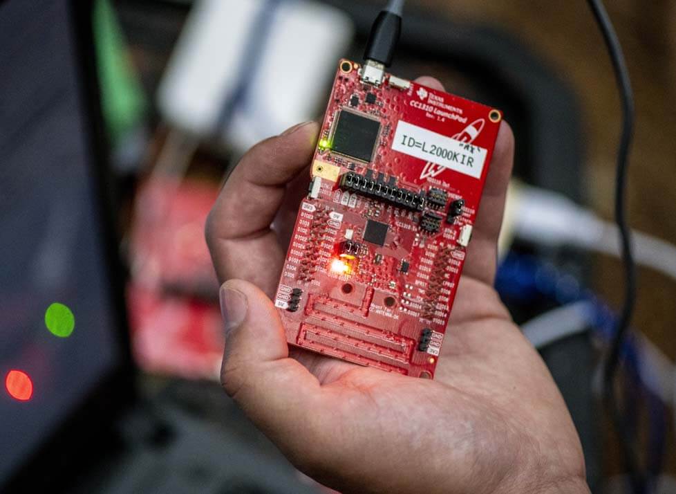 A photo of a hand holding a computer component