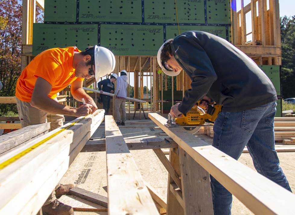 A photo of two engineers working on a construction site