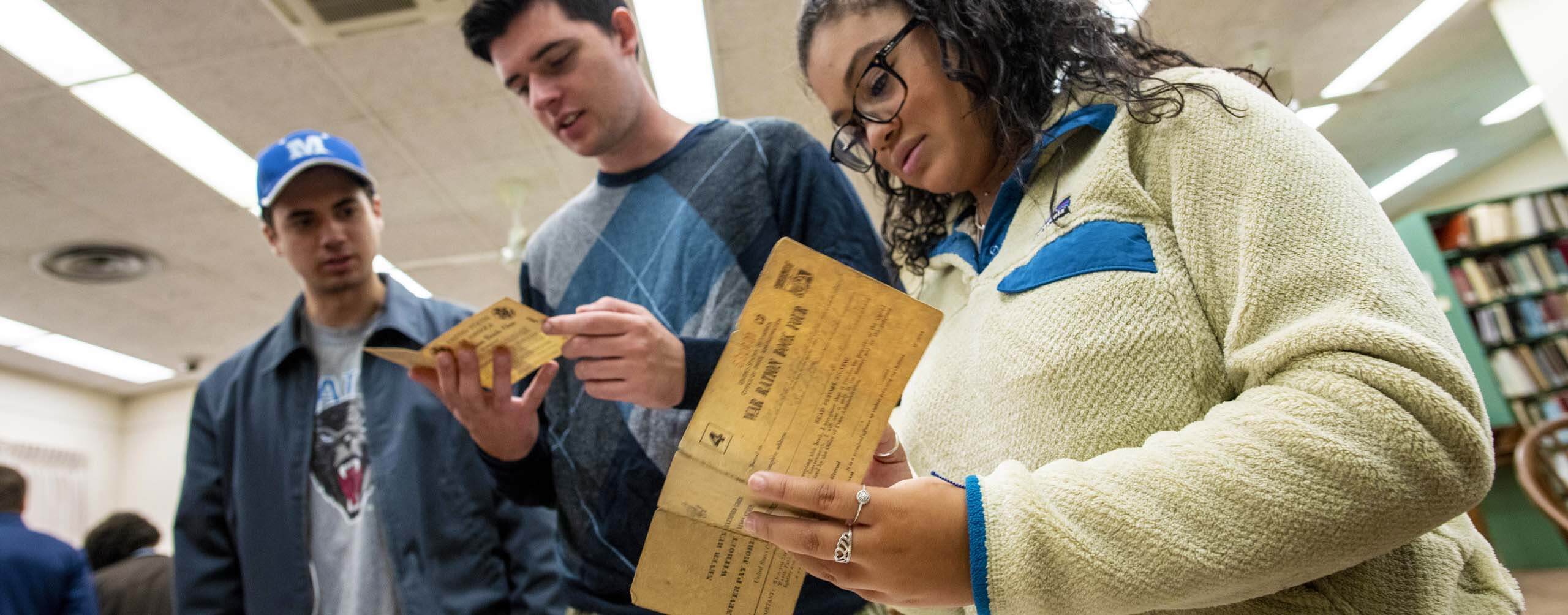 A photo of history students looking at historical documents