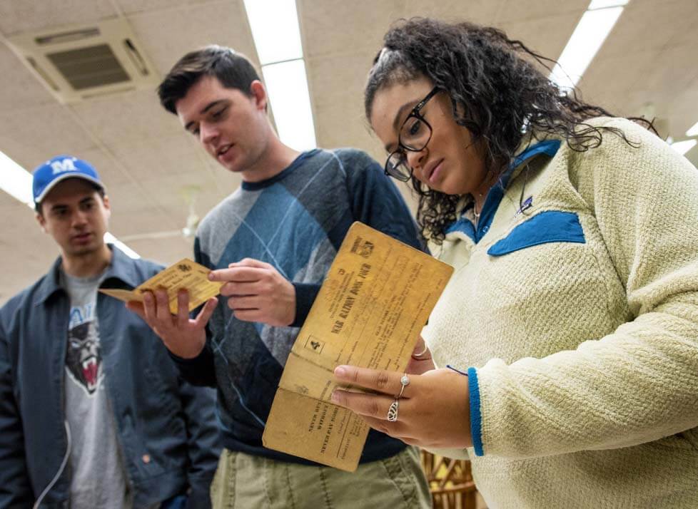 A photo of history students looking at historical documents