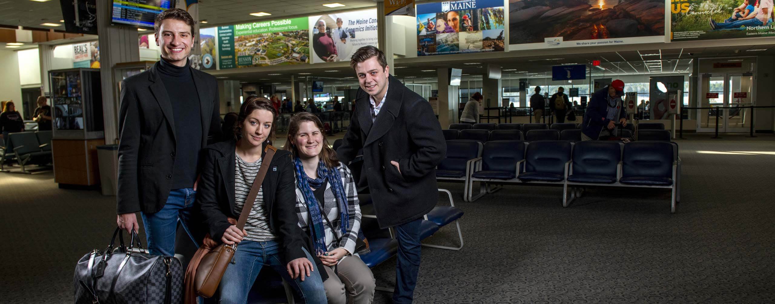 A photo of four international affairs students at Bangor International Airport
