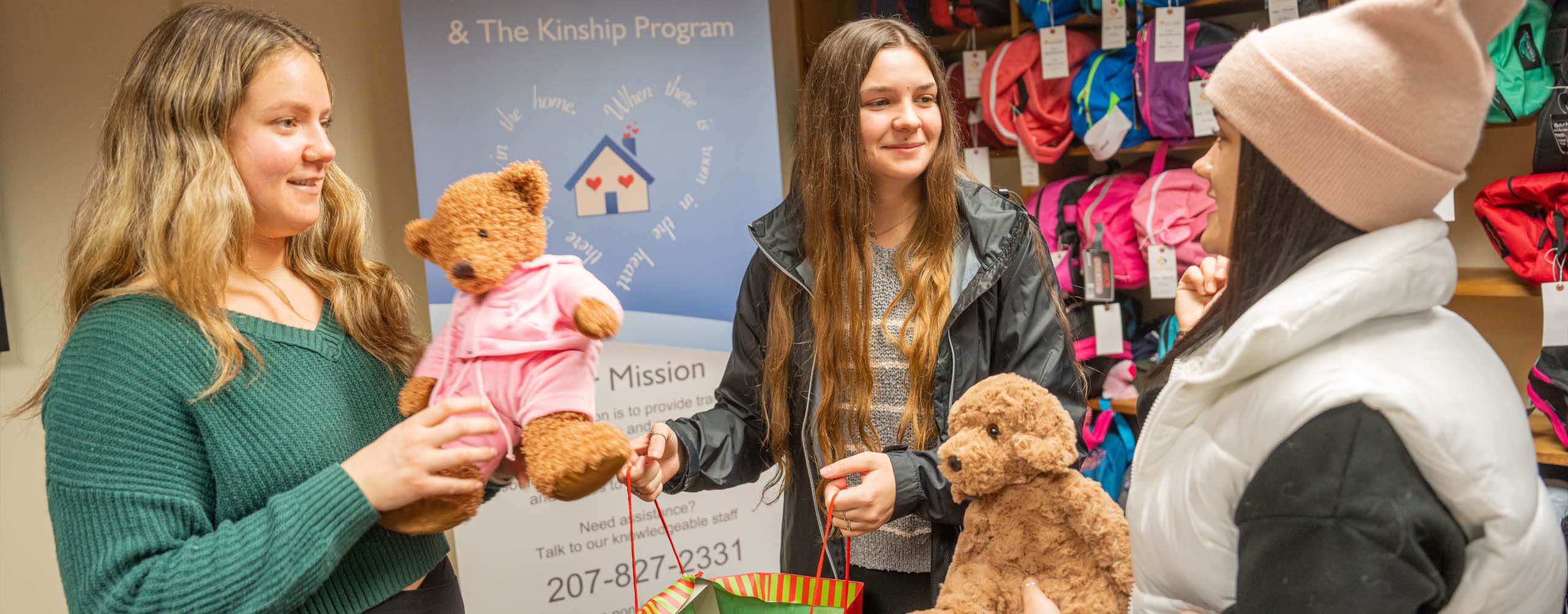 A photo of three social work students gathering items for donation