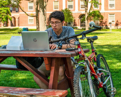 Student studying at a picnic table