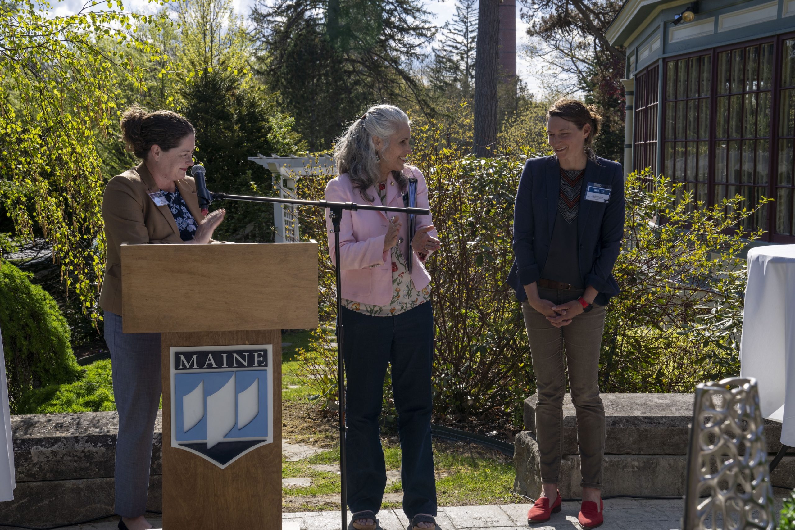Hannah Carter and Dean Diane Rowland awarding a faculty member at a Promotion & Tenure event