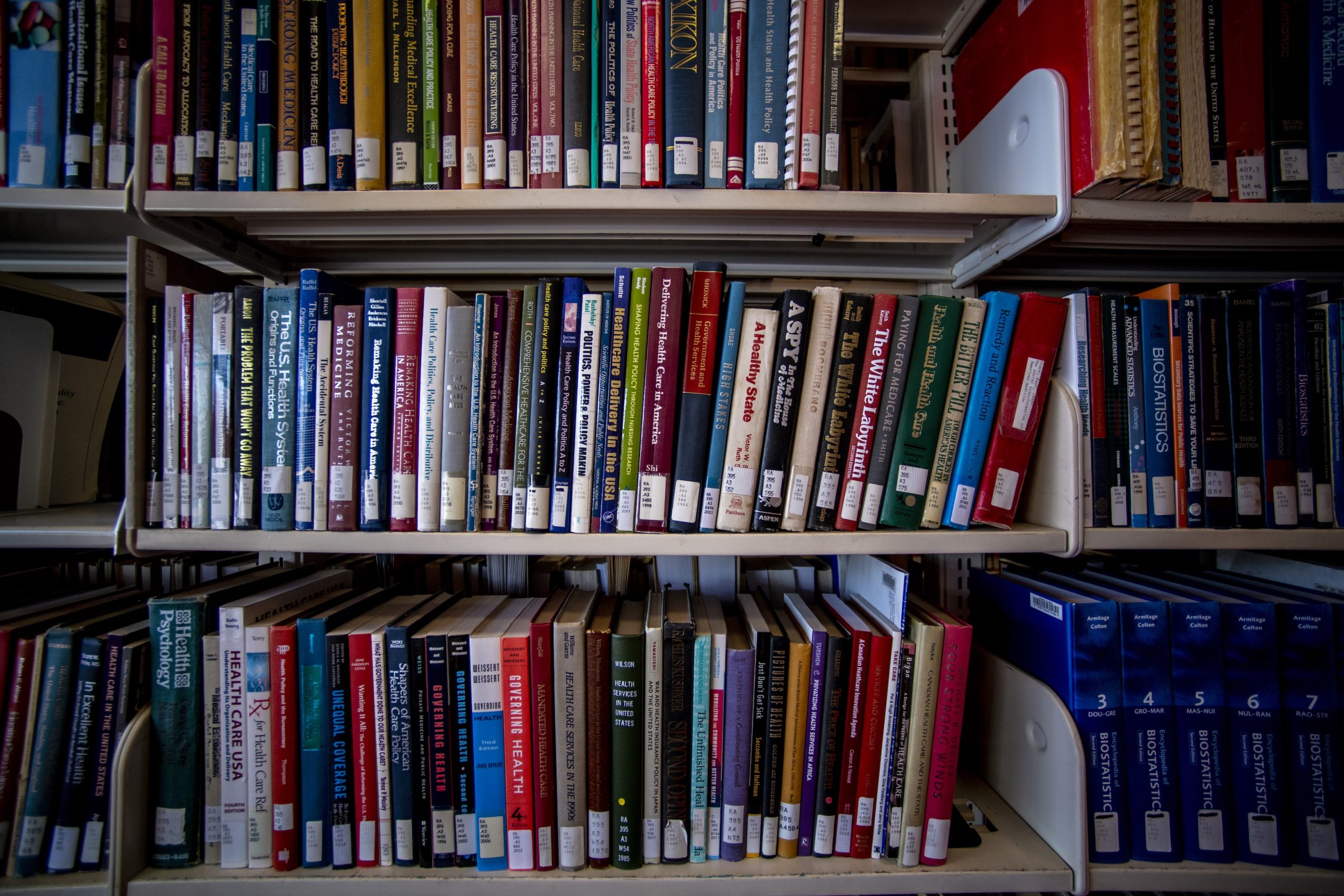 Picture of colored books on a shelf in Fogler Library on the University of Maine campus.
