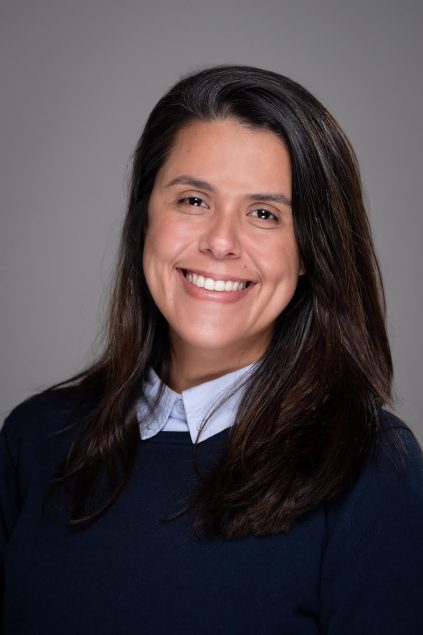 Julia Barra Netto-Ferreira smiling and wearing a collared shirt