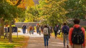 A photo of people walking on UMaine's Mall in fall