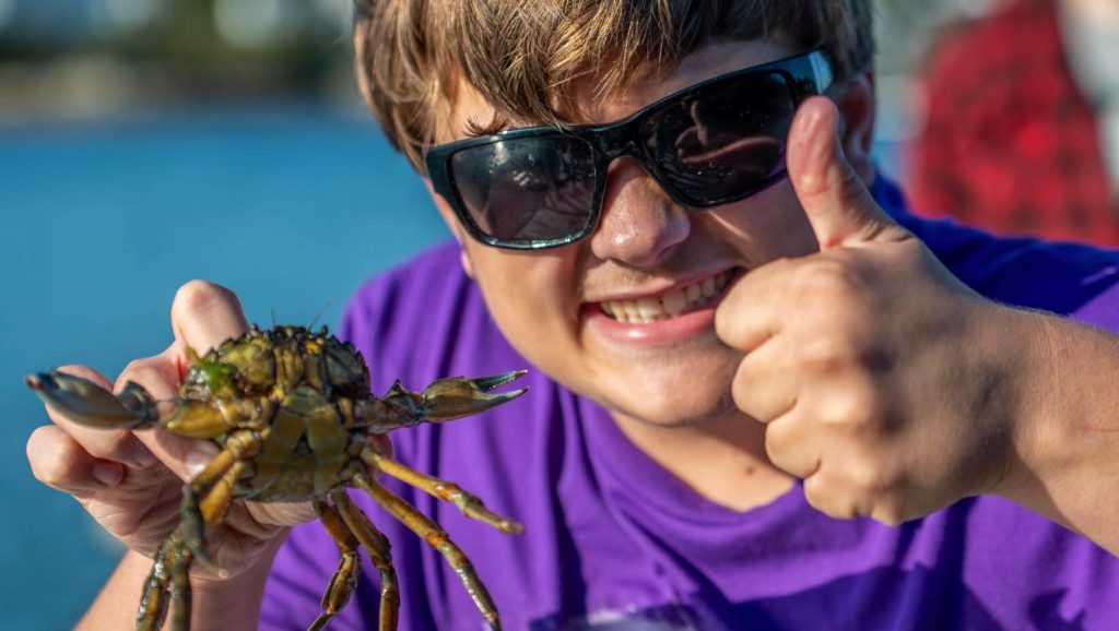 A photo of a person holding a crab