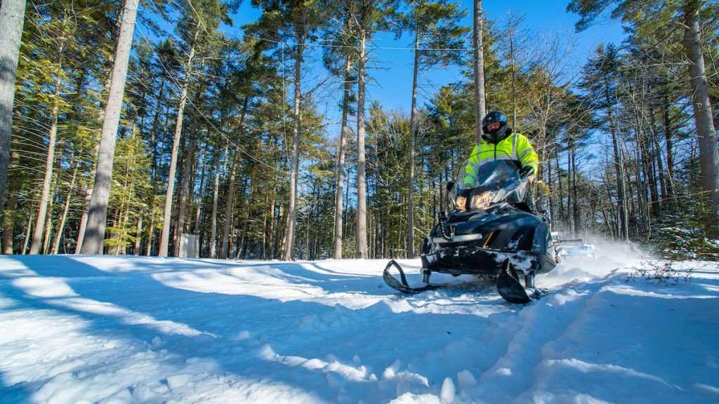 A photo of a man on a snowmobile