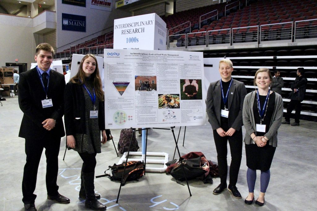 4 students with their poster at the UMaine research symposium