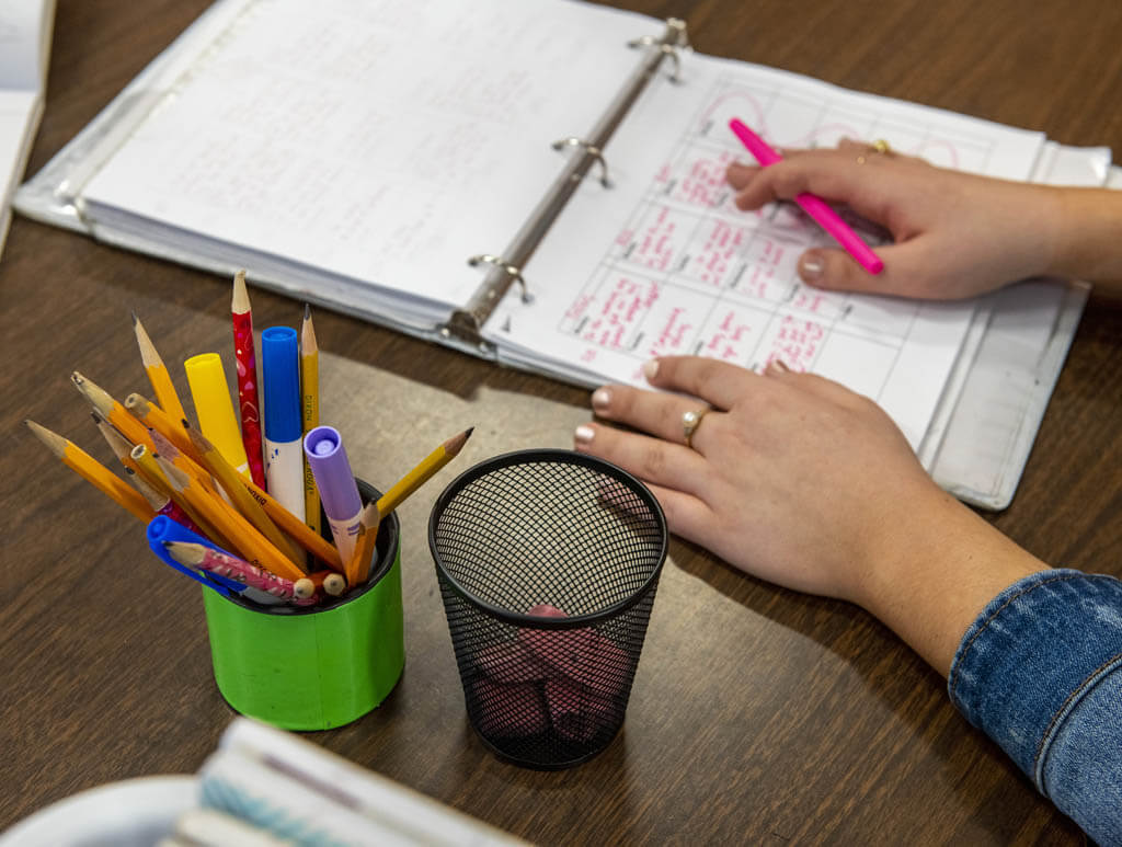 A photo of a binder and markers