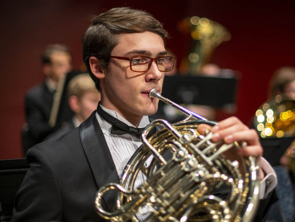 Musician playing a French horn