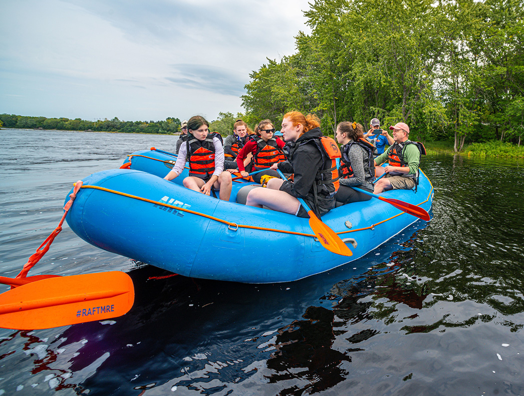 Students in a raft on river