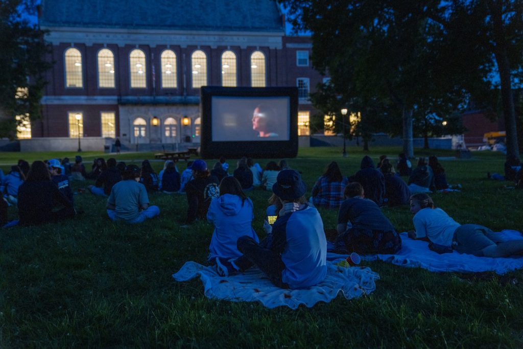 A photo of students watching an outdoor movie on the mall