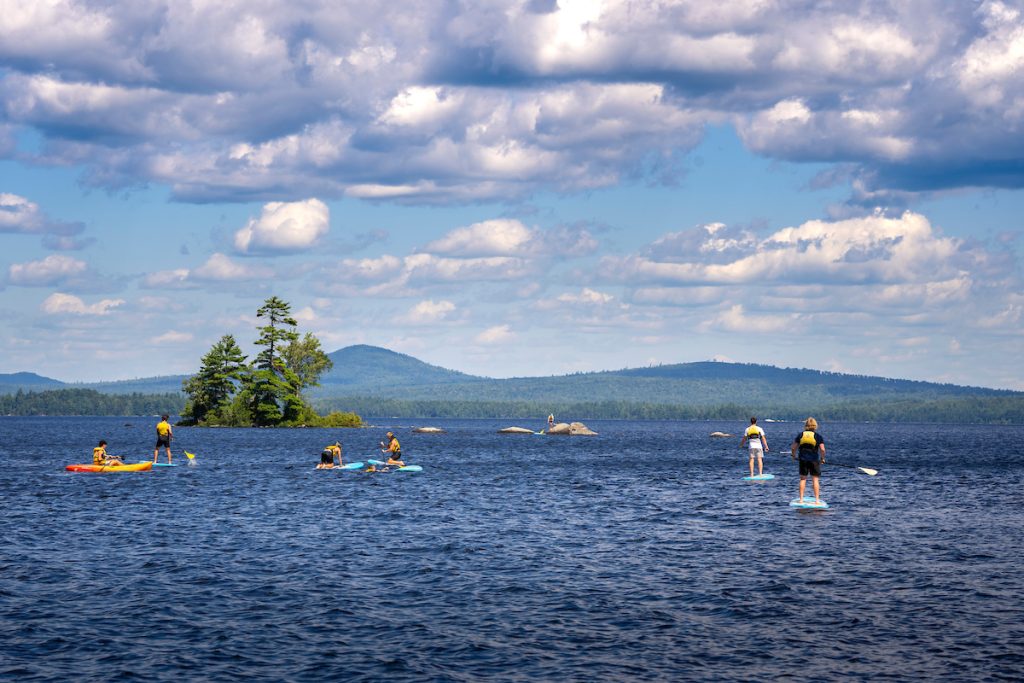 A photo of students paddling on a lake