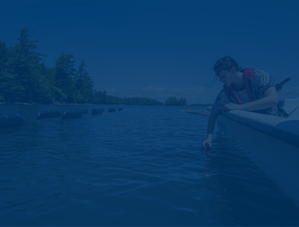 A photo of a student working at an oyster farm with a blue overlay