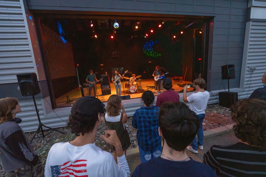 A photo of students listening to a band