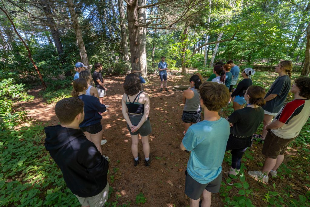 A photo of students gathering in a circle outdoors