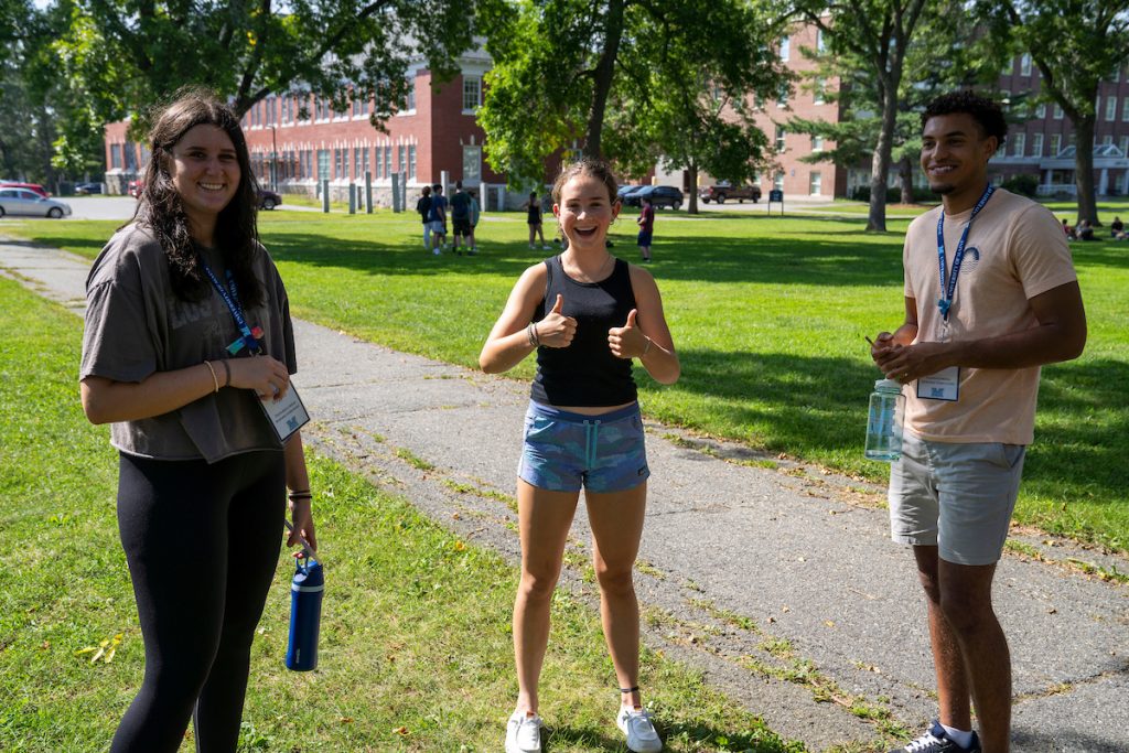 A photo of students smiling and giving a thumbs up