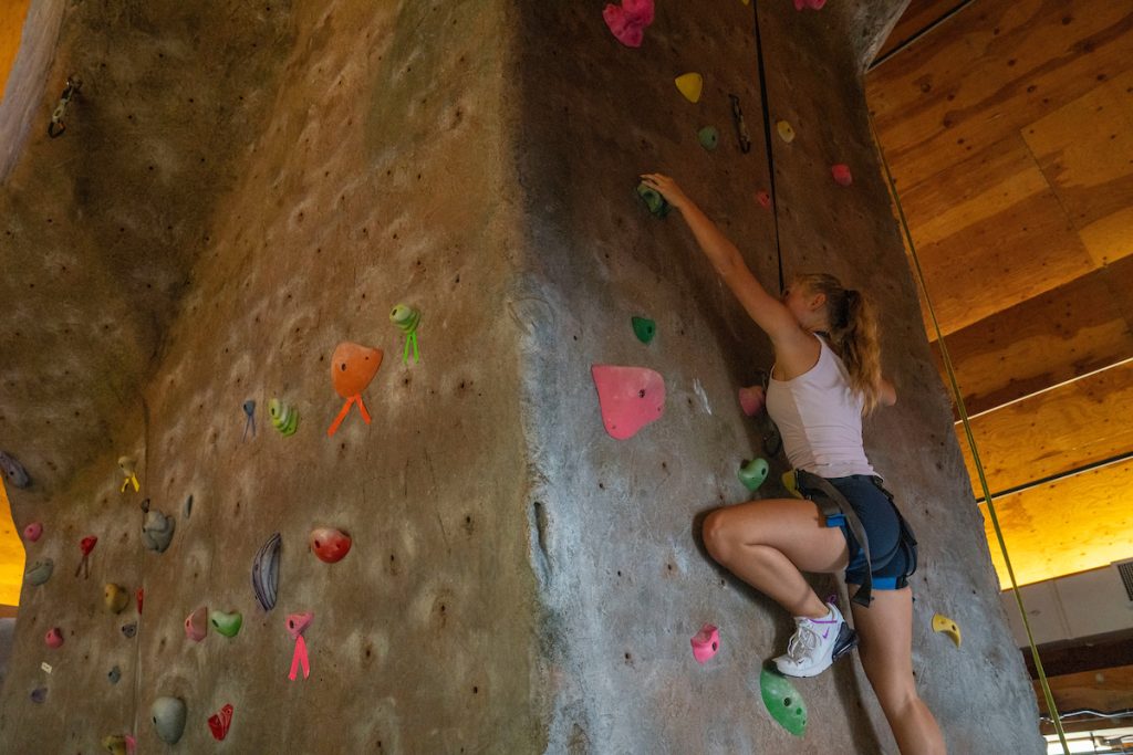 A photo of a student climbing on a rock wall